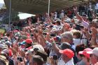 Fans in the SRC grandstand applaud the drivers home after the race