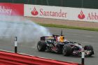 Smoke pours from the back of the Red Bull